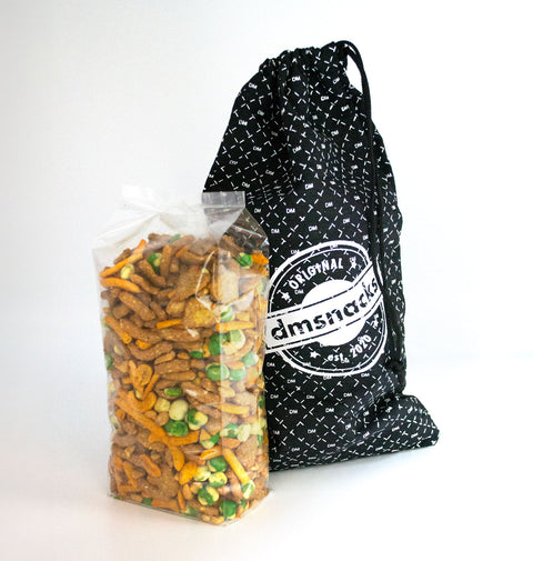 One-pound bag of Damn, Man Taproom Nut Mix next to a branded giftable canvas bag