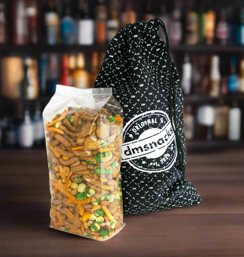 One-pound bag of Damn, Man Taproom Nut Mix with branded canvas gift bag in taproom setting