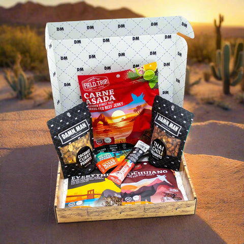 Adventure Tour Nut and Meat Gift Box with Damn, Man Snacks Thai Chili, Carne Asada, Coconut Chili Clusters, and more in desert setting