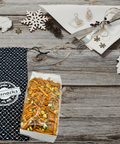 Damn, Man Taproom Nut Mix Bag - 1 Pound savory snack blend in a giftable canvas bag on a rustic wooden table with festive decor.