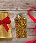 Wooden gift box with red bow and a 1-pound bag of Taproom Nut Mix on rustic wooden background