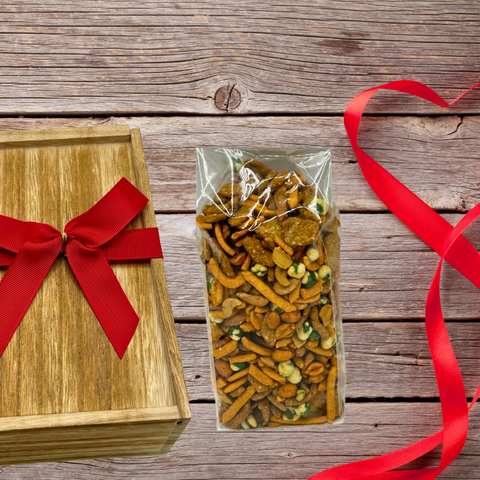 Wooden gift box with red bow and a 1-pound bag of Taproom Nut Mix on rustic wooden background