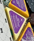 Closeup of Cheddar Cheeses Damn Man Delicatessen Gift Box