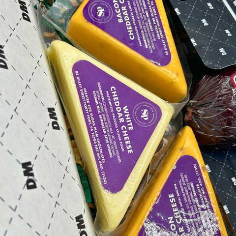 Closeup of Cheddar Cheeses Damn Man Delicatessen Gift Box