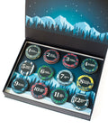 12 Days of Gourmet Nuts Winter Wonderland Selection, open calendar box displaying nut snacks with a mountain and forest background.