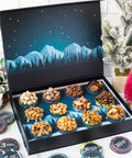 12 Days of Gourmet Nuts Winter Wonderland Selection in open box with alpine scene, showcasing assorted delicious nut snacks