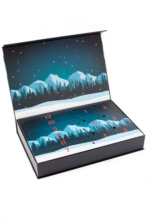 Winter-themed advent calendar box for 12 Days of Winter Wonder - Savory Meat Sticks & Nut Medley with numbered compartments.