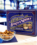 Spirits & Whisky Peanuts Men's Gift Tin in blue packaging with a bowl of gourmet peanuts, featuring Pale Ale, Moonshine, and Bourbon flavors.