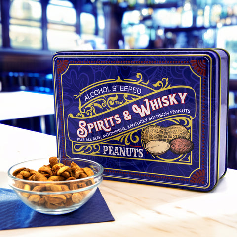 Spirits & Whisky Peanuts Men's Gift Tin in blue packaging with a bowl of gourmet peanuts, featuring Pale Ale, Moonshine, and Bourbon flavors.