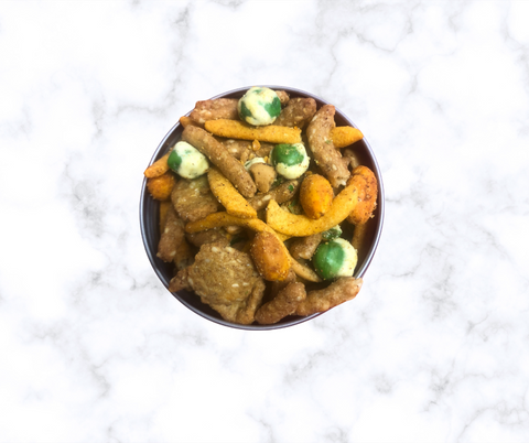 Taproom Nut Mix in a bowl on a marble surface - perfect snack with a sweet and spicy flavor for pairing with beer or drinks