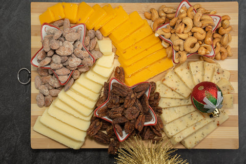 Signature Nuts and Cheese Box with assorted flavored pecans, almonds, cashews, and premium cheeses on a festive holiday platter